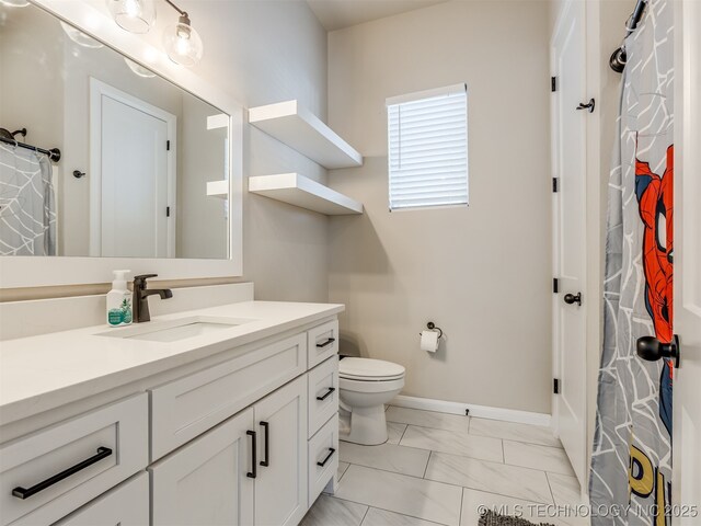 bathroom with toilet, walk in shower, and vanity