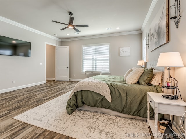 bedroom featuring hardwood / wood-style floors, ceiling fan, and ornamental molding