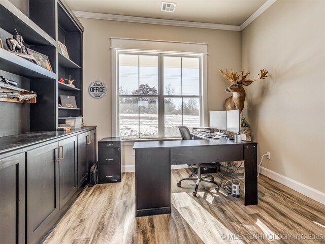 office area with light hardwood / wood-style floors and ornamental molding