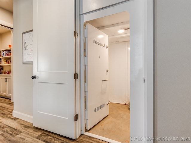 corridor with light hardwood / wood-style flooring