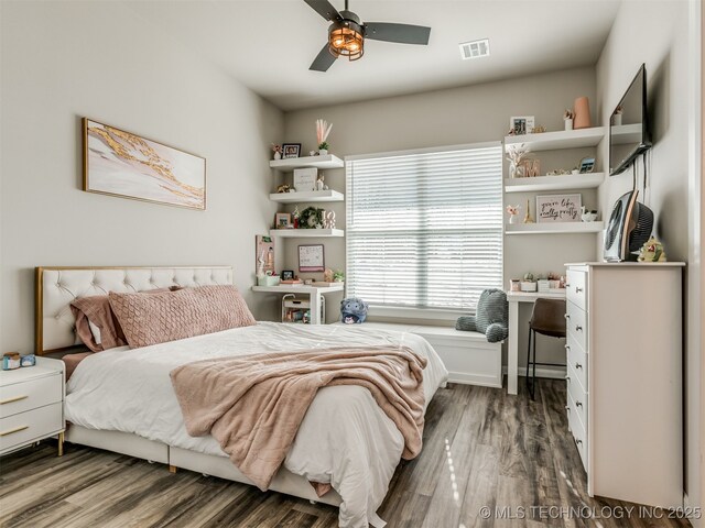 bedroom with ceiling fan and dark hardwood / wood-style floors