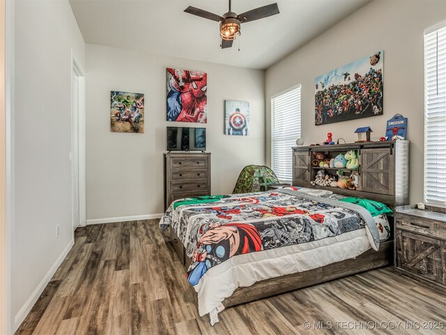 bedroom with ceiling fan and wood-type flooring