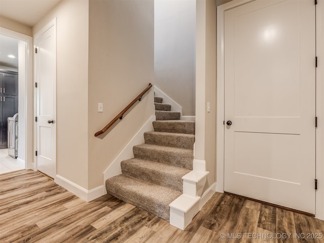 stairs featuring wood-type flooring