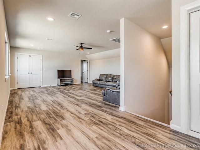 unfurnished living room featuring ceiling fan and light hardwood / wood-style floors