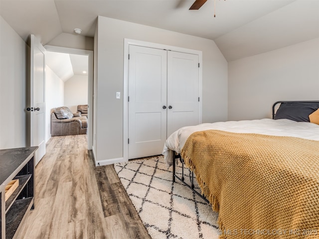 bedroom featuring ceiling fan, a closet, lofted ceiling, and hardwood / wood-style flooring