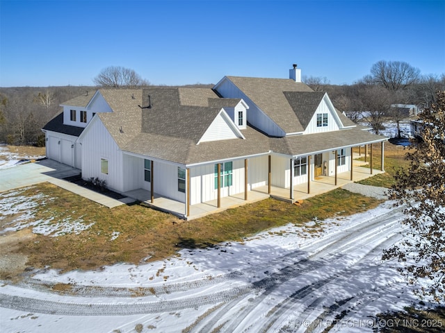 view of snow covered back of property