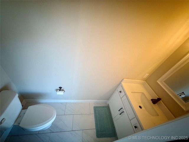 bathroom featuring toilet and vanity