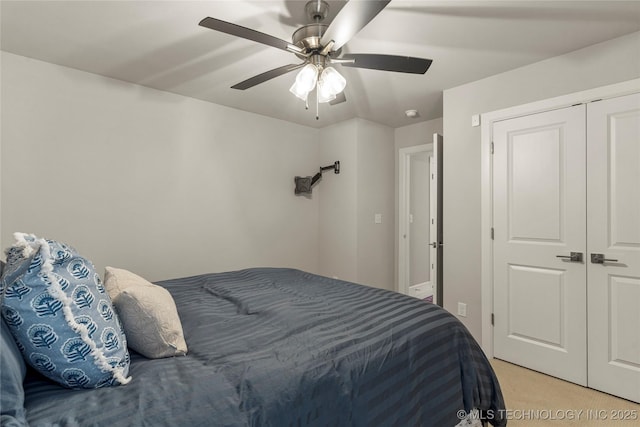 bedroom with a closet, light colored carpet, and ceiling fan