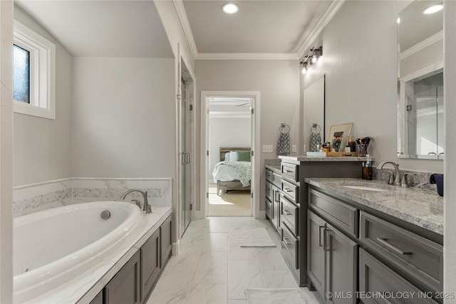 bathroom with a tub to relax in, vanity, and ornamental molding