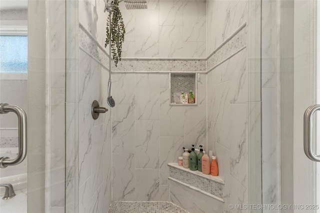 bathroom featuring a shower with shower door