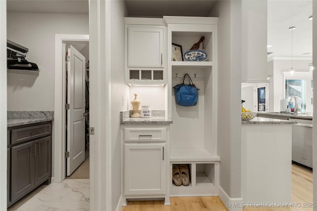 mudroom featuring crown molding and sink