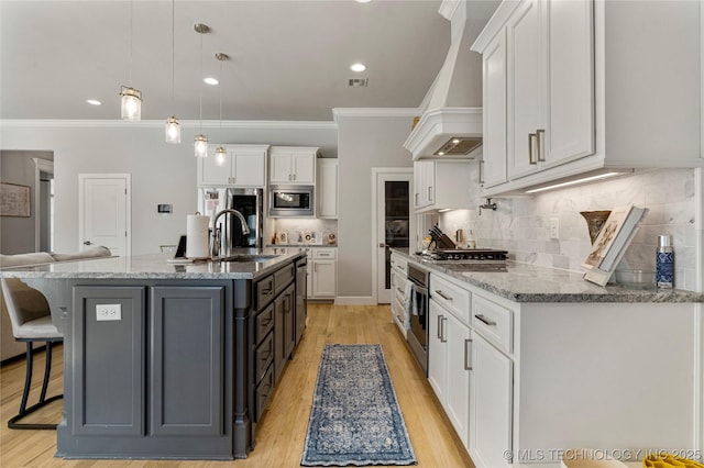 kitchen featuring sink, stainless steel appliances, decorative light fixtures, white cabinets, and custom exhaust hood