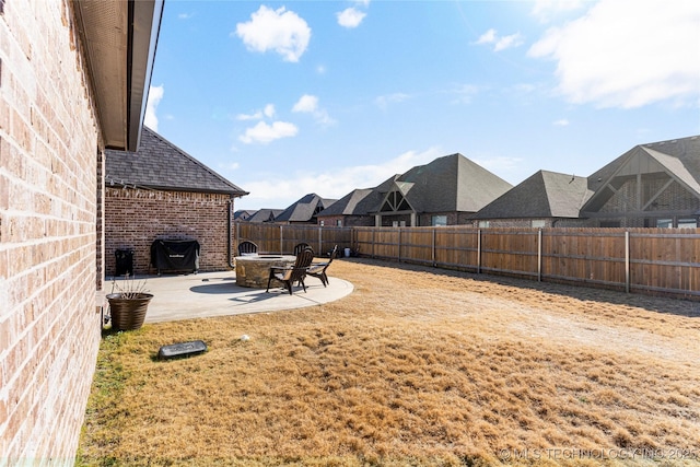 view of yard with a patio and an outdoor fire pit