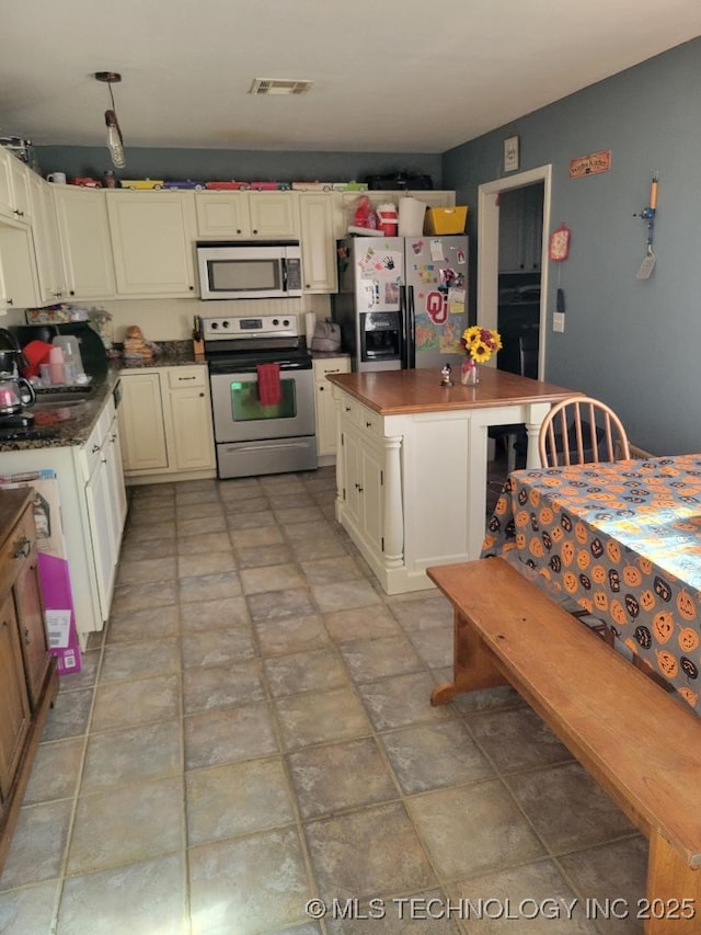 kitchen with a kitchen island and appliances with stainless steel finishes