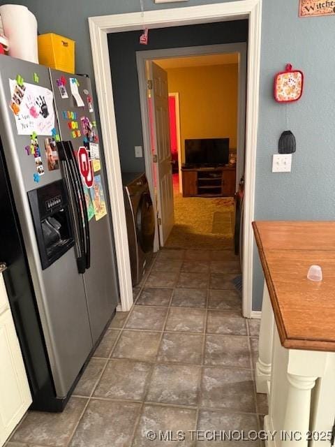 kitchen featuring stainless steel refrigerator with ice dispenser