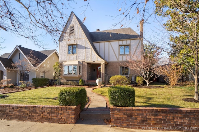 tudor home featuring a front yard