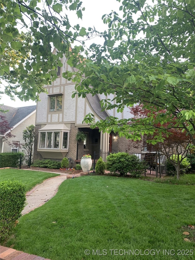 tudor house featuring a front lawn