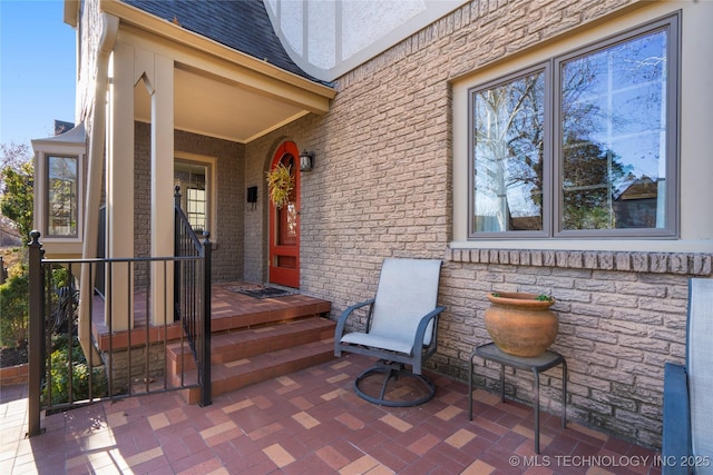 view of exterior entry featuring a patio area