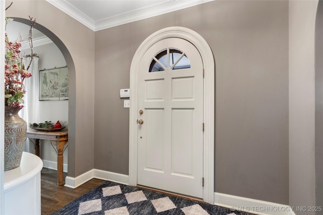 foyer featuring crown molding and dark wood-type flooring