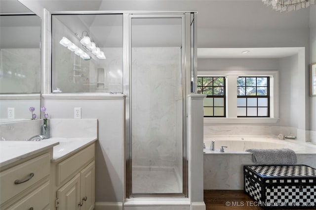 bathroom featuring vanity, hardwood / wood-style floors, and separate shower and tub