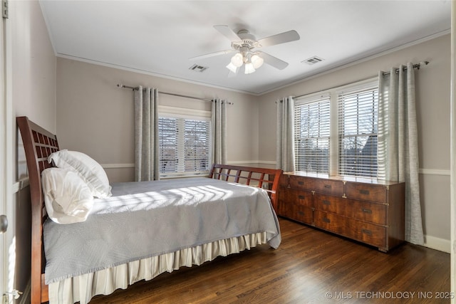 bedroom with ceiling fan, dark hardwood / wood-style flooring, multiple windows, and crown molding