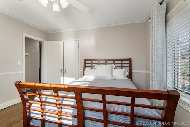 bedroom featuring ceiling fan, ornamental molding, and dark hardwood / wood-style floors