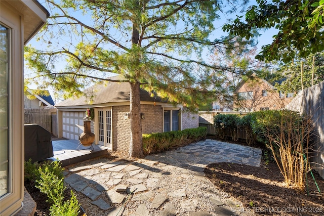 view of home's exterior featuring a patio area and a garage