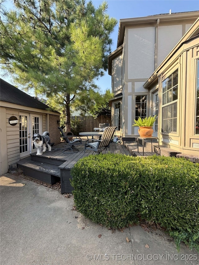 view of yard with french doors and a wooden deck