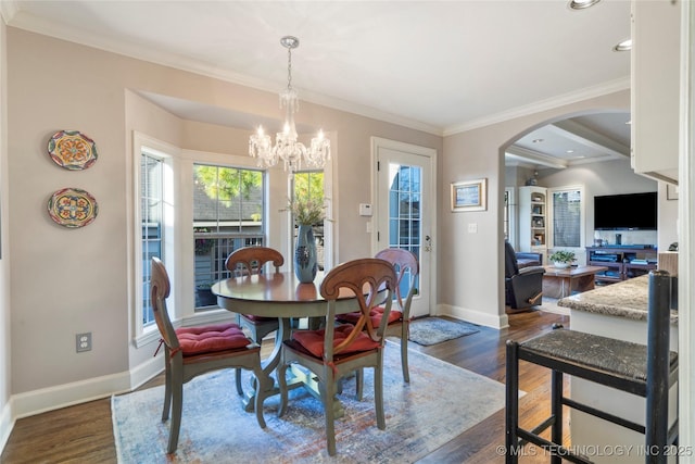 dining room featuring dark wood-type flooring, an inviting chandelier, and ornamental molding