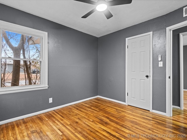 unfurnished bedroom featuring ceiling fan and wood-type flooring