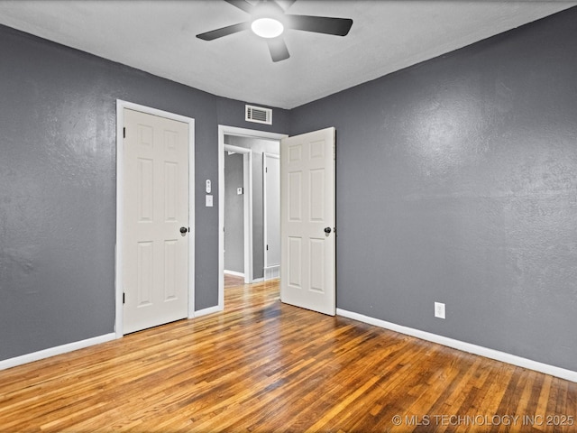 unfurnished bedroom with hardwood / wood-style floors and ceiling fan