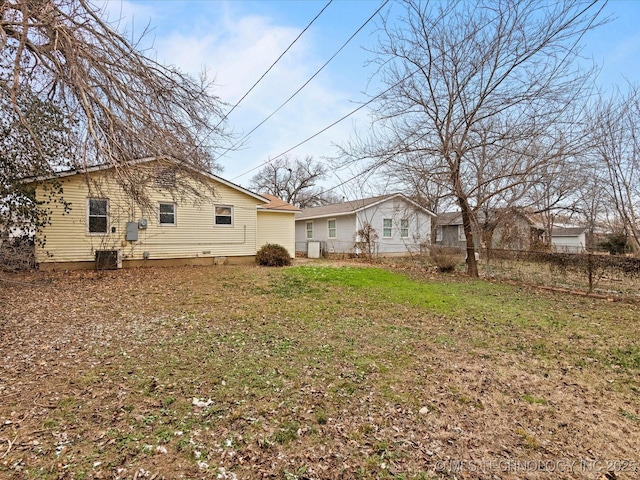 back of property with a lawn and central AC unit