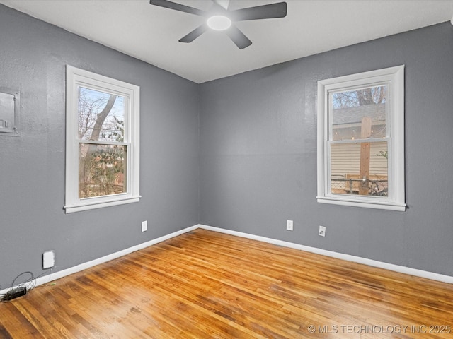 unfurnished room featuring hardwood / wood-style flooring, ceiling fan, and a healthy amount of sunlight