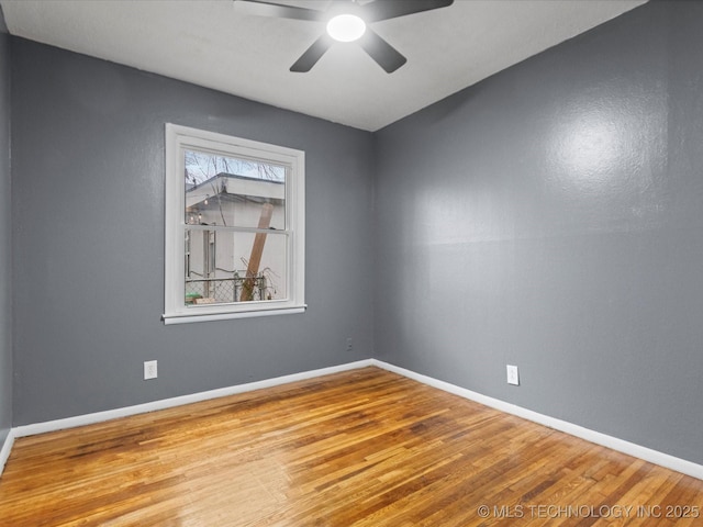 spare room featuring ceiling fan and hardwood / wood-style flooring