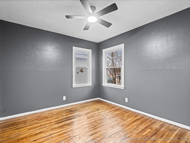 spare room featuring light hardwood / wood-style flooring and ceiling fan