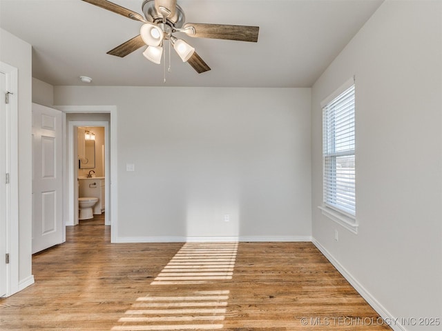 spare room featuring light wood-type flooring and ceiling fan