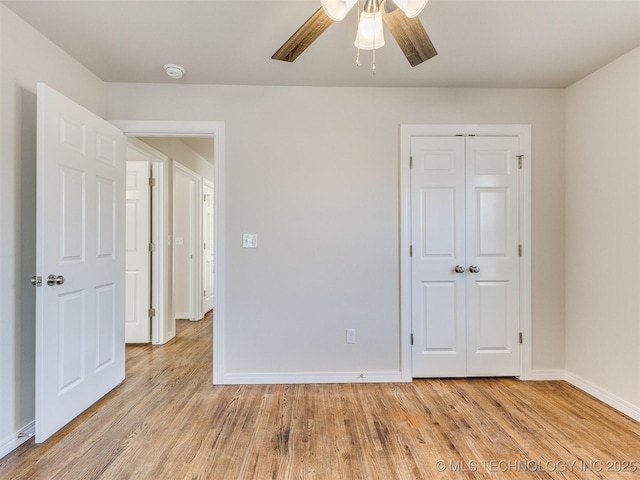 unfurnished bedroom with ceiling fan, light hardwood / wood-style floors, and a closet