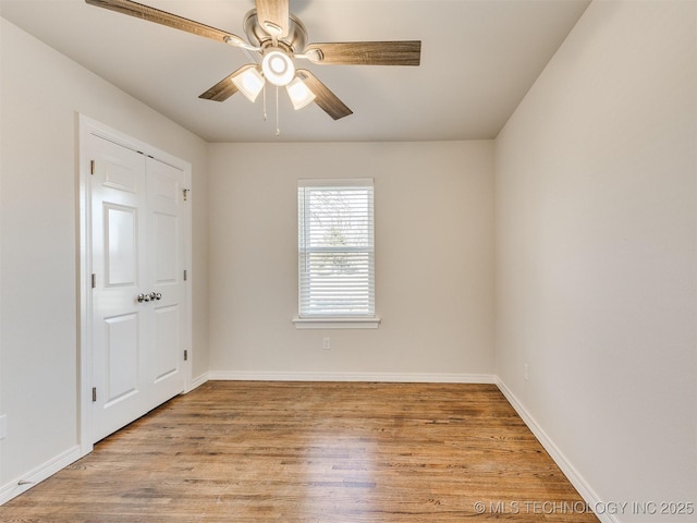 spare room with light wood-type flooring and ceiling fan