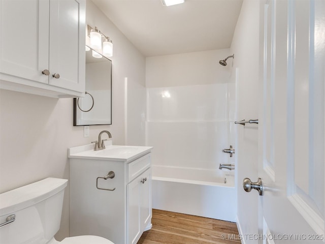 full bathroom featuring toilet, shower / washtub combination, vanity, and hardwood / wood-style flooring