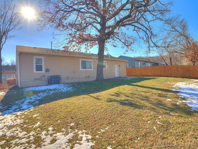 back of house featuring a lawn and central AC unit