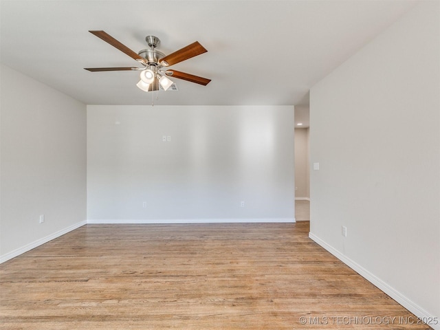 empty room featuring ceiling fan and light hardwood / wood-style flooring