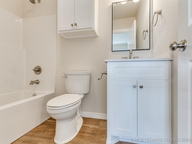 full bathroom with bathing tub / shower combination, toilet, vanity, and wood-type flooring