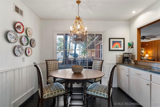 dining area with crown molding and ceiling fan with notable chandelier