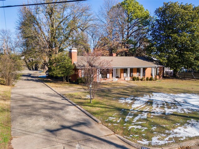 view of front of house featuring a lawn and covered porch