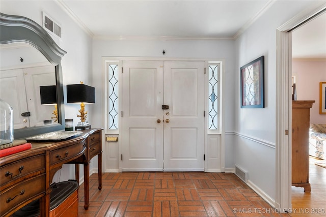 foyer entrance featuring ornamental molding