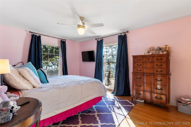 bedroom featuring hardwood / wood-style flooring and ceiling fan