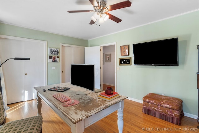 office area with light hardwood / wood-style flooring, ornamental molding, and ceiling fan