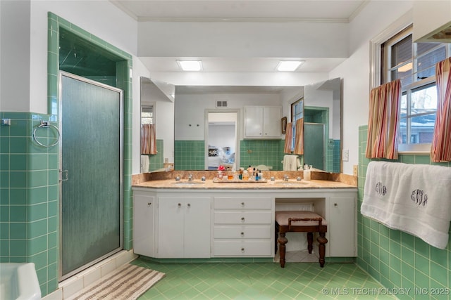 bathroom featuring vanity, ornamental molding, tile walls, and walk in shower