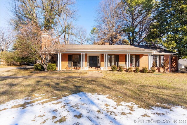 ranch-style home featuring a yard and a porch