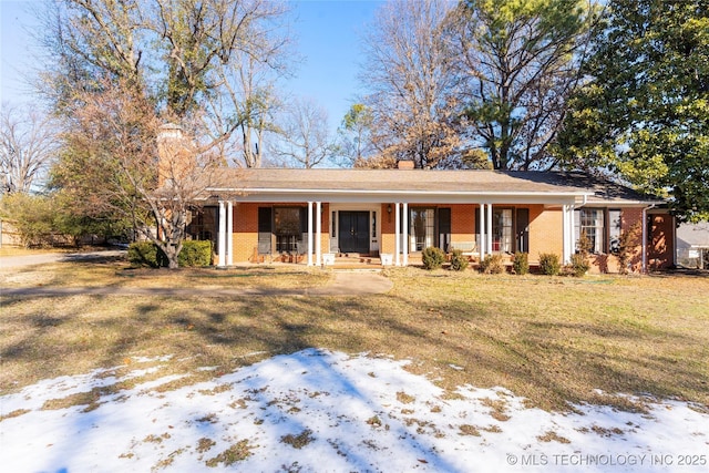 ranch-style house featuring a yard and a porch